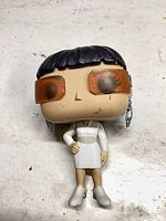 Front view of Funko Pop showing sunglasses, dress and boots