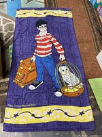 Full view of licensed Harry Potter terry towel showing design and borders