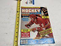 Front cover of Hockey Illustrated January 1985 magazine with measurement tape for scale