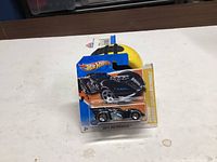 Front view of sealed Hot Wheels Batman Arkham Asylum Batmobile on blister card