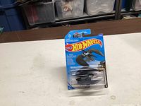 Front view of sealed Hot Wheels Batman Batwing on card