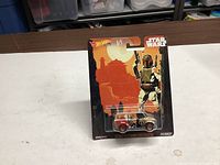 Front view of sealed Hot Wheels Star Wars Boba Fett character car on blister card
