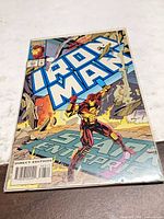 Front cover of Iron Man #303 comic showing artwork, condition issues visible
