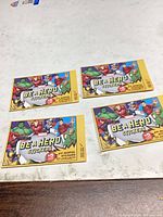 Four Marvel “Be A Hero” sticker packs laid out