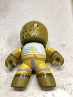 Front view of Mighty Muggs reptile figure showing overall design and wear
