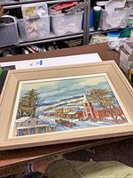 Full view of framed winter village painting