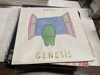 Front cover of Genesis "Duke" LP atop stack