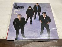 Front sleeve of The Pretenders Learning to Crawl LP on table