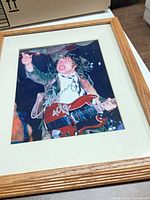 Full view of framed signed photo with wood frame and mat