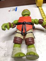 Front view of Raphael action figure lying flat