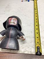 Front view figure beside tape measure indicating height