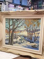 Front view of framed winter landscape painting