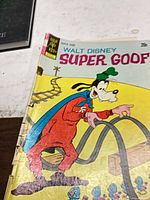 Front cover showing title, publisher logo and character with visible creases and wear