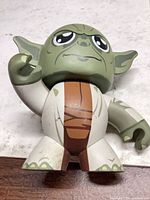 Front view of stylized Yoda vinyl figure showing overall appearance and scuffs