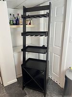 Front view showing full cabinet with shelves, stemware racks and wine bottle compartment