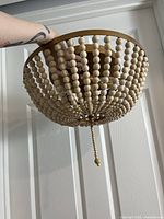Side view of ceiling light showing bead strands and frame