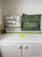 Both pillows side by side with tape for scale