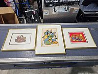 Overall view of three framed prints on table