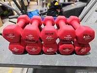 Ten red 6-lb Element Fitness hex dumbbells stacked in two rows
