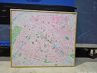 Full view of framed Paris map showing gold metal frame and map detail