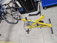 Full view of LeMond yellow spin bike showing frame, handlebars, monitor, missing seat
