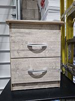 Front view showing two drawers and handles