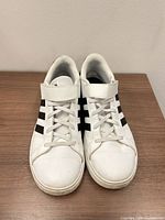 Top view of both sneakers showing laces, strap, and overall condition