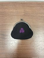 Front view of coin purse showing embroidery and frame