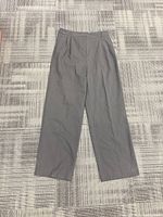 Full view of charcoal dress pants laid flat showing style and condition