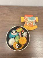 Box opened showing dolls and balls inside