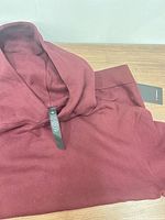 Folded hoodie showing color and interior brand tag