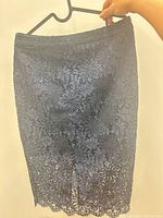 Front view of navy floral lace pencil skirt hanging