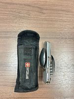 Multi-tool folded next to nylon pouch