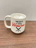 Front view showing text and baseball graphic on mug
