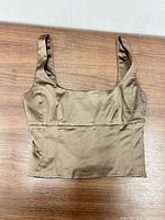 Front view of taupe-brown satin crop tank top