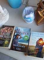 Paperback books, globe container, part of bear figurine
