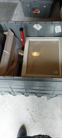 Grey tote containing picture frame, tools and boxes