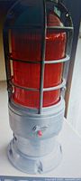 Full view showing red lens and metal cage