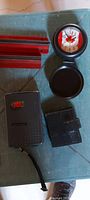 Close view of multimeter, red magnet block, travel clocks and clock cover