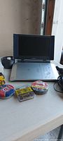 Toshiba portable DVD player with tape rolls and blade pack visible