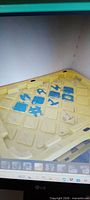 yellow plastic lid with blue markings