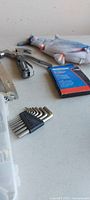 Group showing Allen keys, multi-tool pliers, fish toy, staples pack
