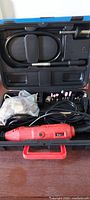 open case showing rotary tool, flexible shaft, accessories
