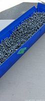 Top view of bin filled with screws