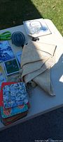 Tabletop view showing coasters stack, runner, bead pack, scissors, blue glass dish and shadow box frames