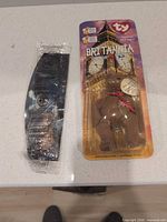 Both sealed toys: Ty Britannia Bear blister card and Swiss Chalet toy in bag