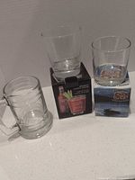 All three drinkware items: beer mug, Smirnoff glass on box, Seagram’s glass on box