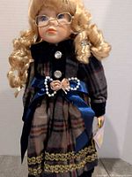 Close-up of doll’s face and upper outfit