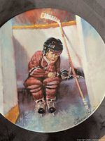 Front view of plate showing hockey boy artwork and artist signature