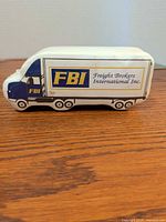 Side view of truck-shaped package with FBI Freight Brokers International branding